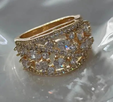 Women's round hollow fashion ring in copper with choice of gold or platinum finish and blue or white stone detail.