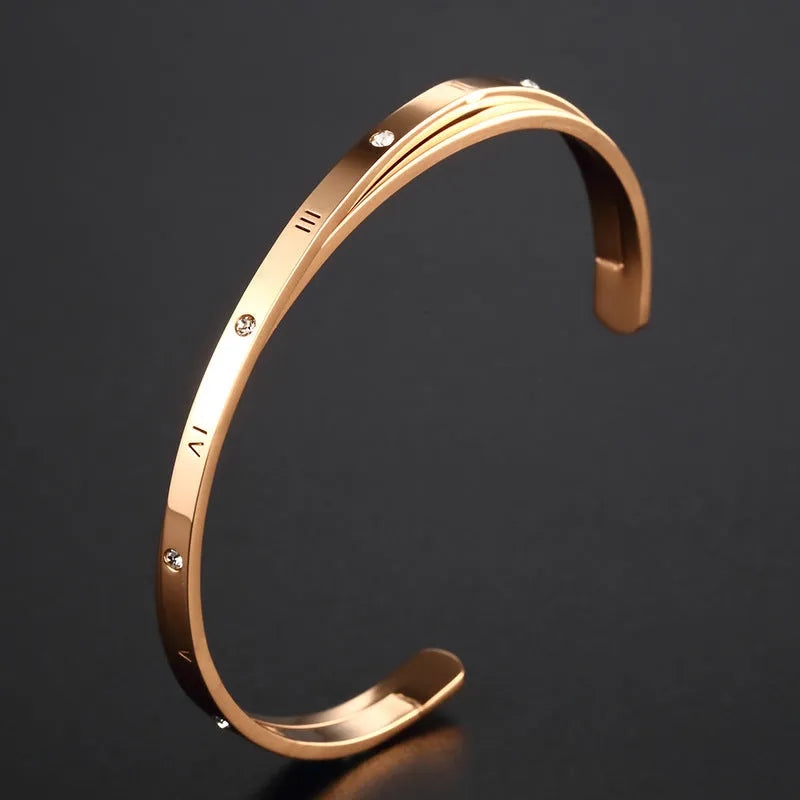 Open-ended stainless steel bracelet with inlaid zircon stones available in gold, rose, and steel colours