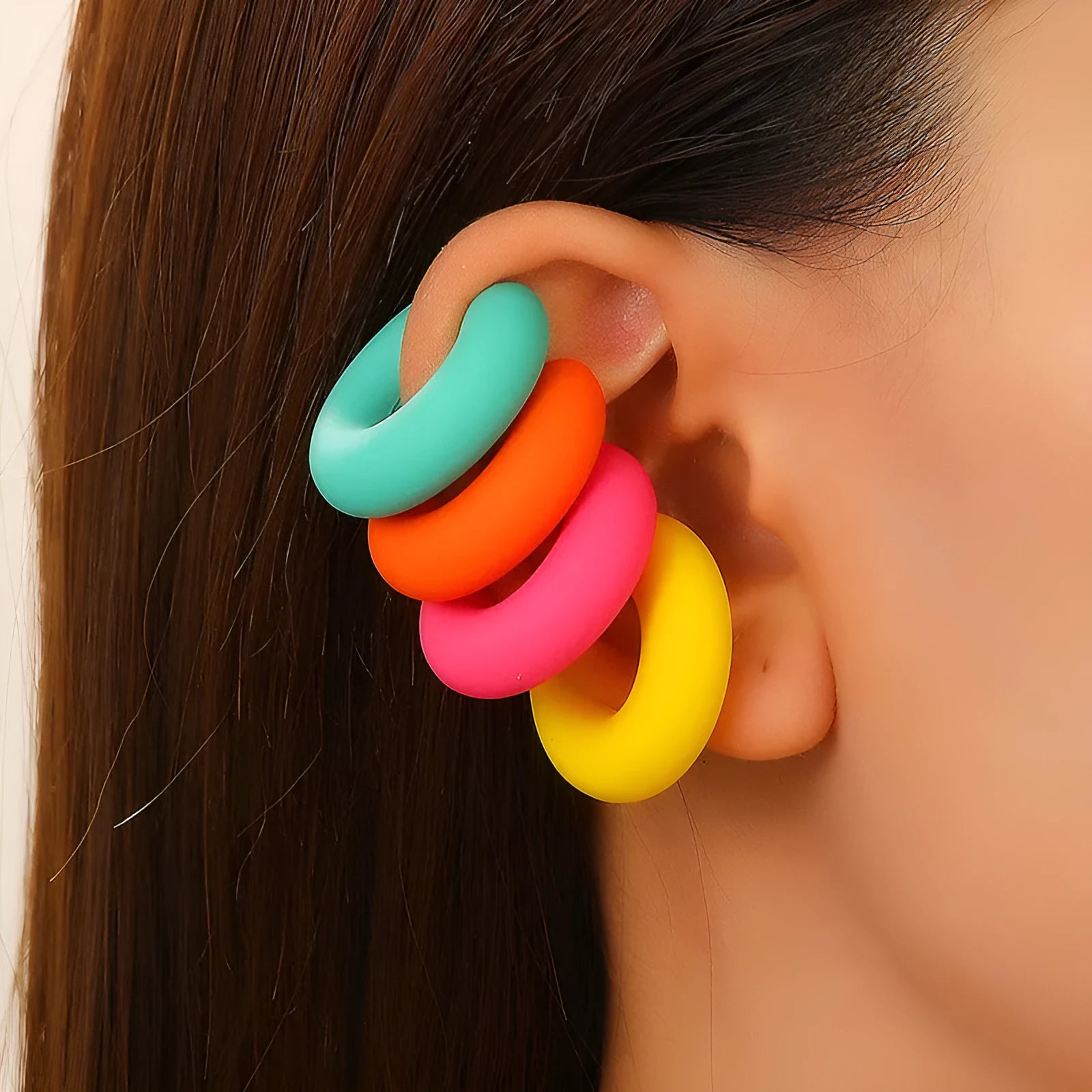 C-shaped clip-on earrings with round geometric shape and matte coarse finish in assorted candy colours.