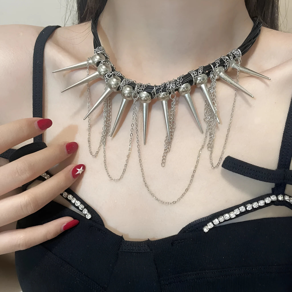 Leather necklace with round beads, a winding tassel, and silver point rivets on a white background.