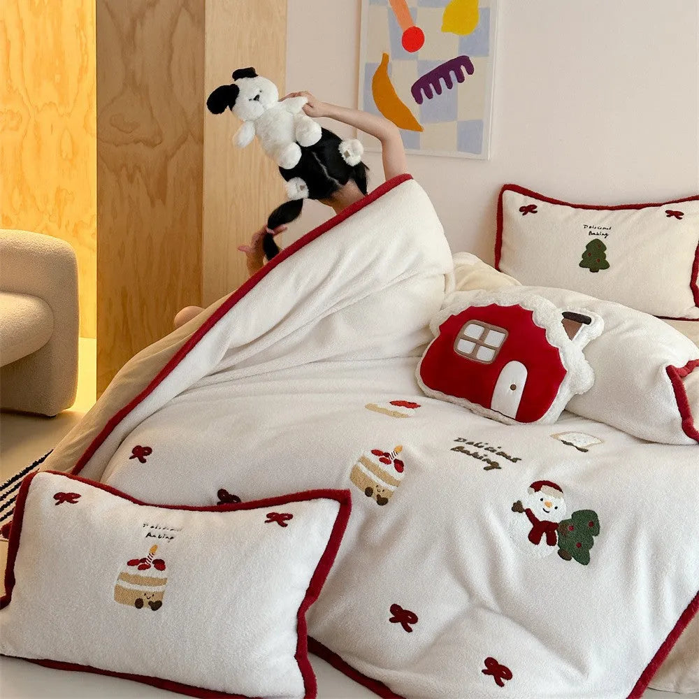 Winter Christmas cartoon patterned bedding four-piece set showing duvet cover, sheet, and pillowcases in pastel colours.