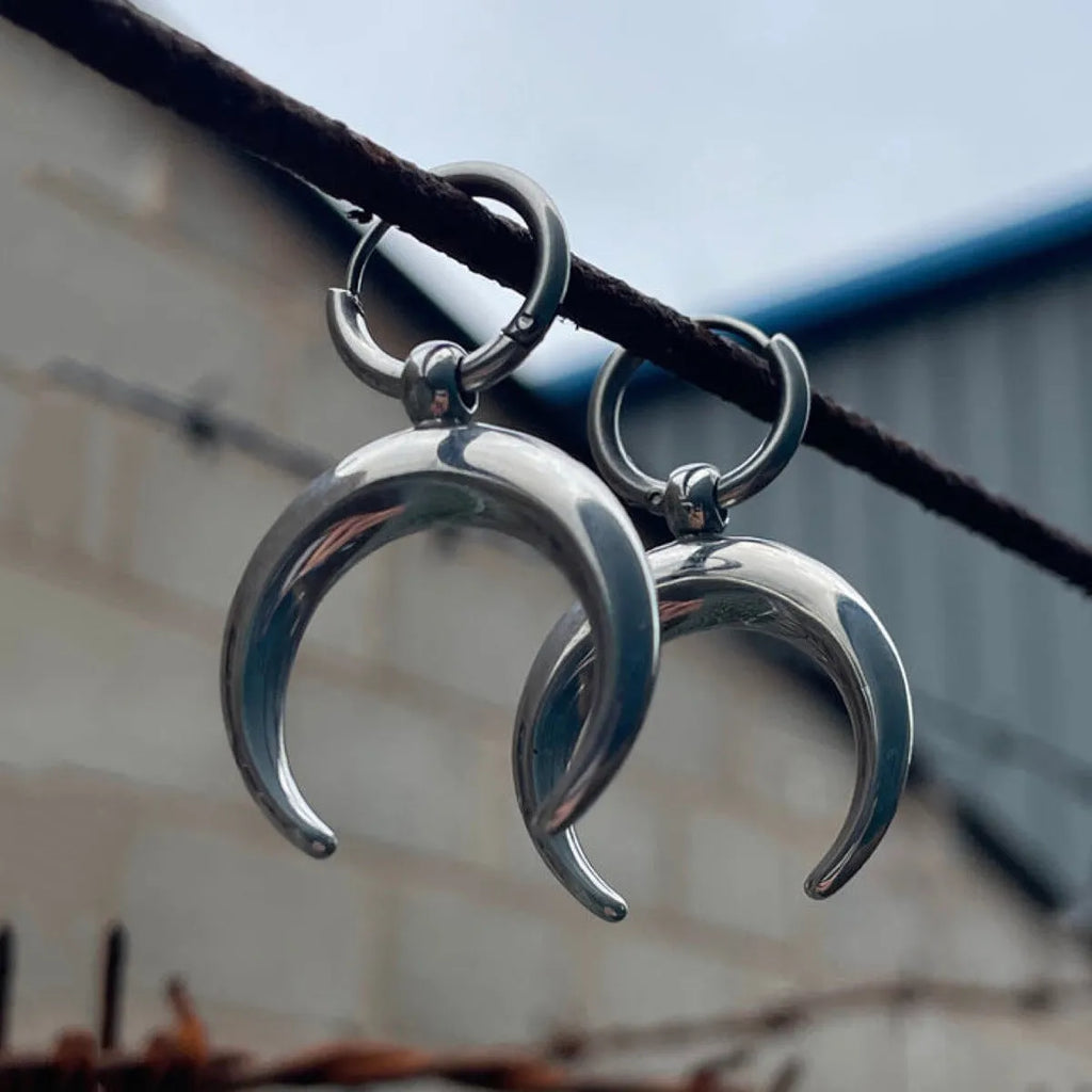 Silver alloy hoop earrings with moon detail and geometric shaping