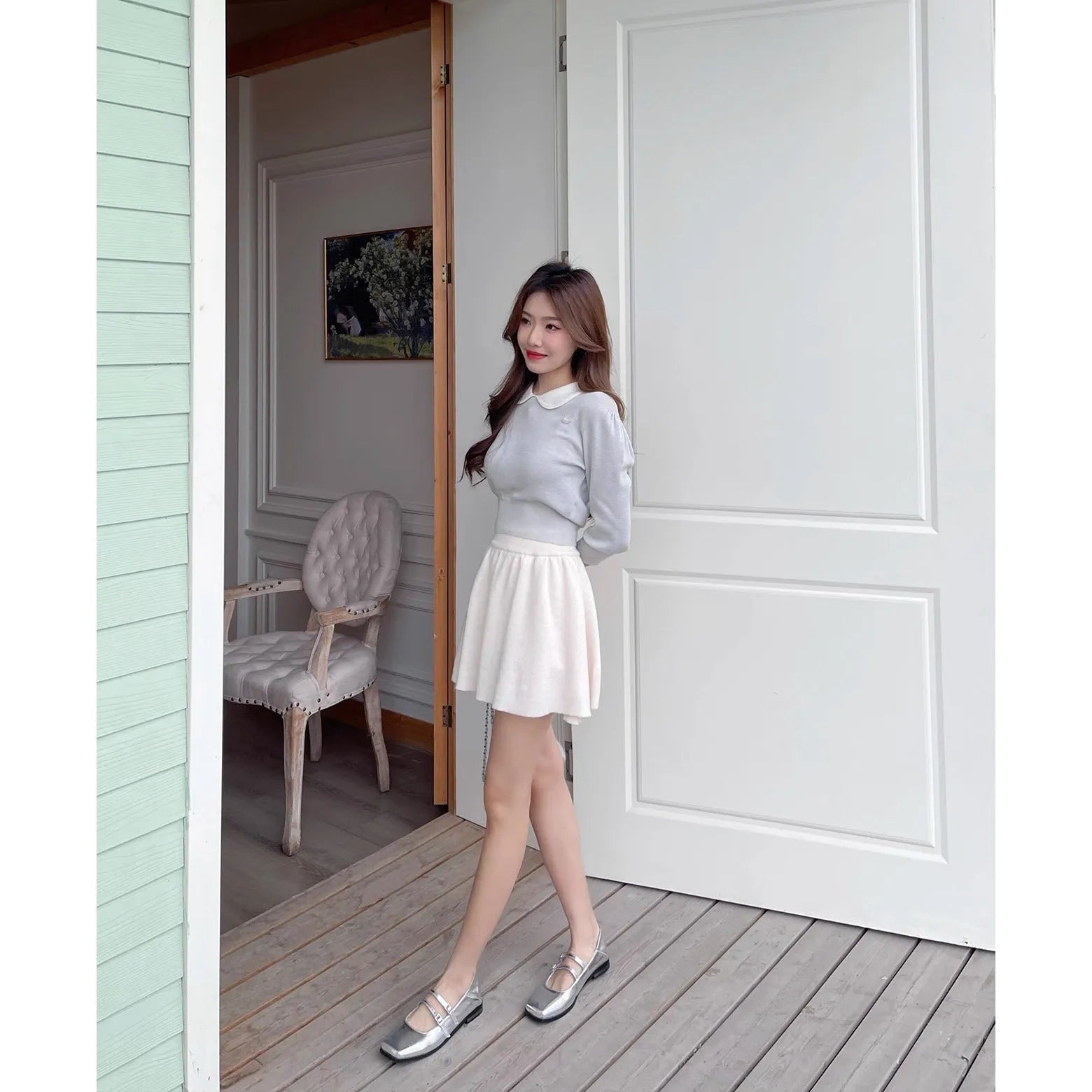 Silver women's leather ballet flats with a cross buckle strap and round toe.