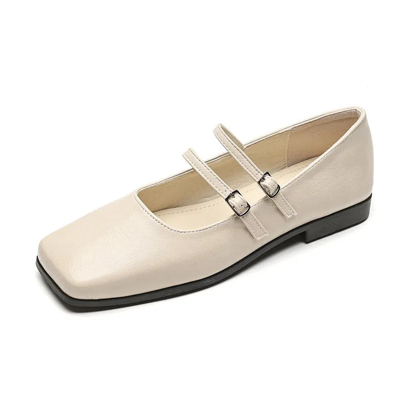 Silver women's leather ballet flats with a cross buckle strap and round toe.