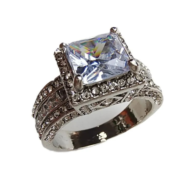 Geometric women's alloy ring in gold tone on a hand, showing round design element and UK size marking.