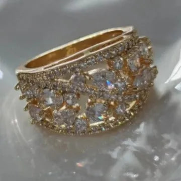 Women's round hollow fashion ring in copper with choice of gold or platinum finish and blue or white stone detail.