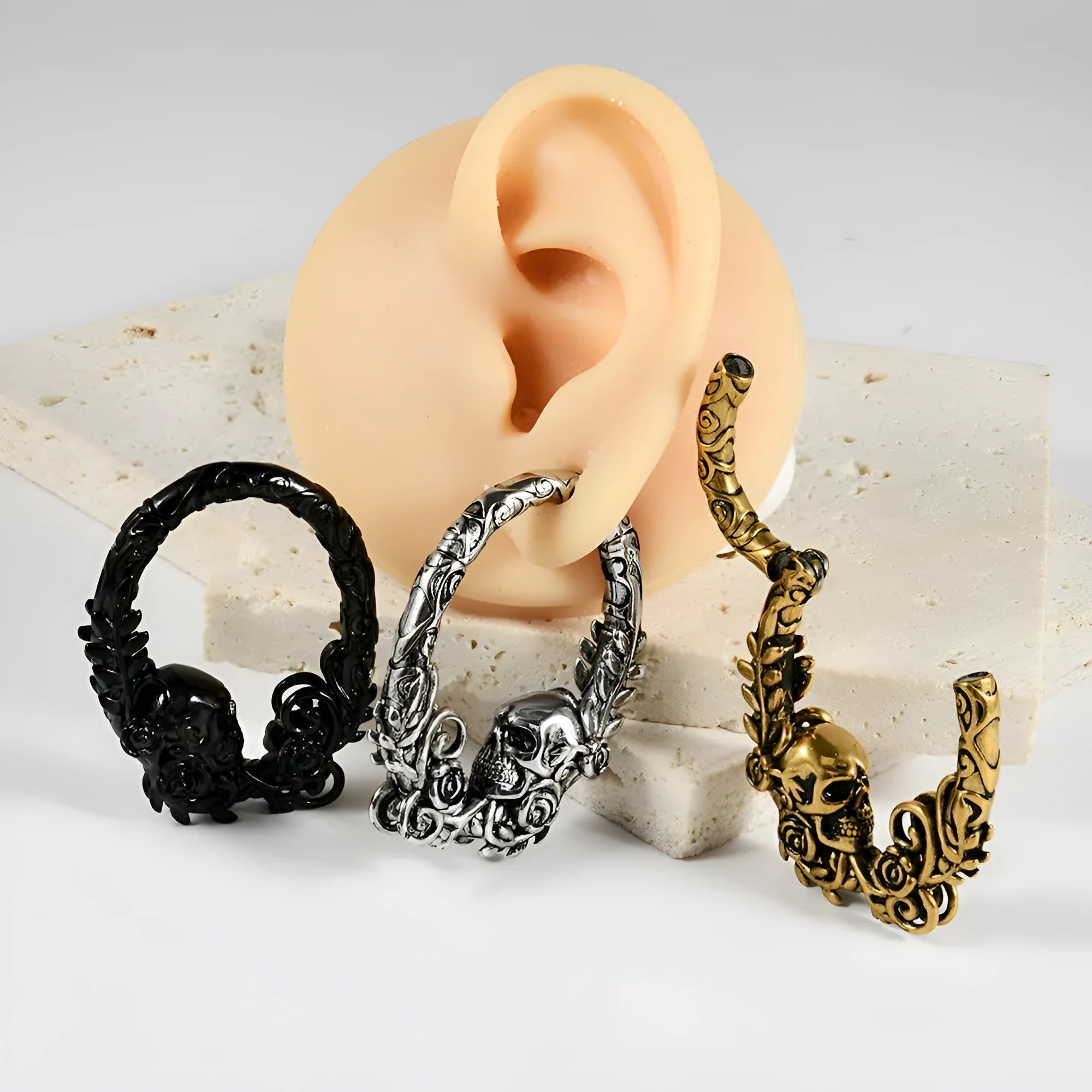 A pair of stainless steel fashion earrings with a geometric totem pattern in an electroplated finish.