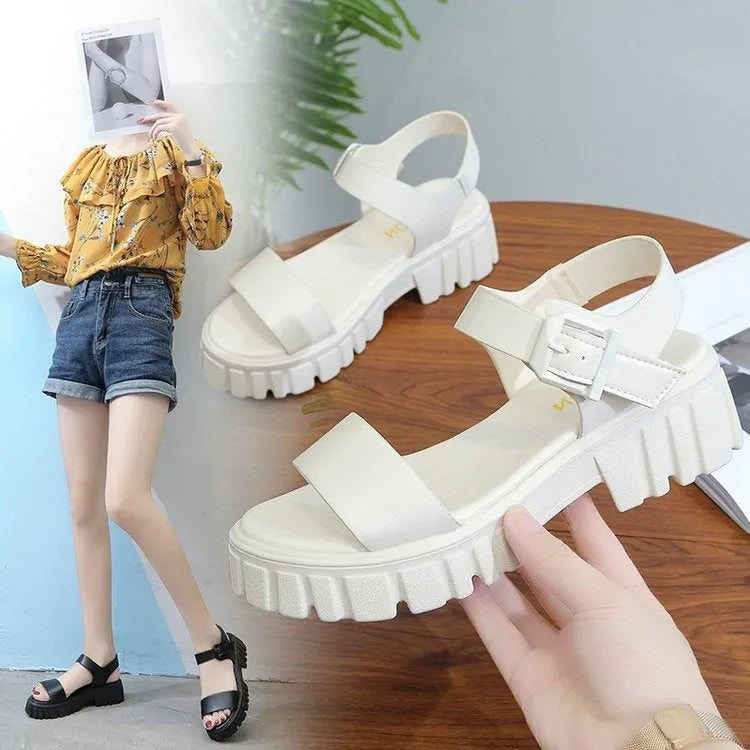 Women's beige peep toe platform sandals with an ankle-strap buckle on a wooden floor.