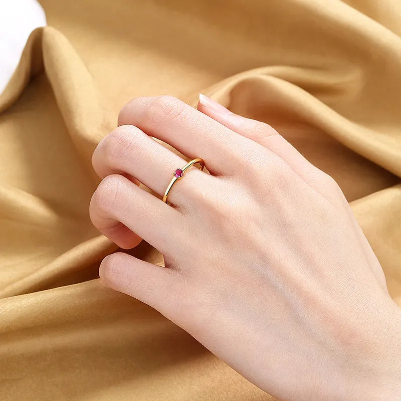 Copper geometric circle ring for women with a single diamond style in blue, green, red, or white on a size guide.
