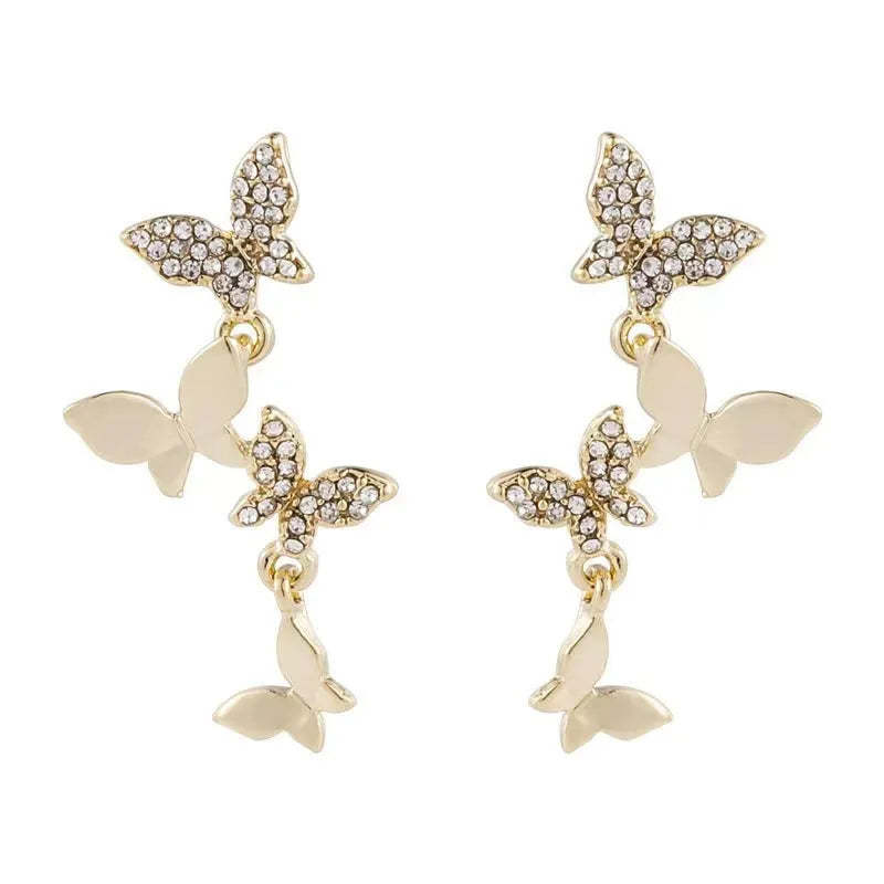 Gold-coloured copper butterfly earrings with four-wing design and drop silhouette for women