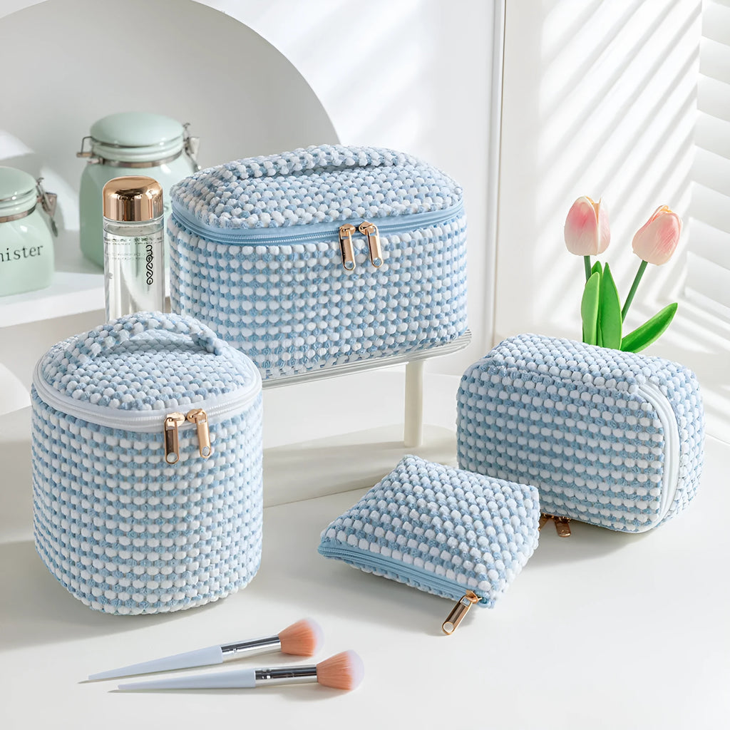 Four cube-shaped flannelette make-up bags in different colours: pink, khaki, pink dots, blue dots