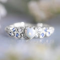Peach-coloured heart-shaped women's ring with flower and opal ocean design on alloy metal