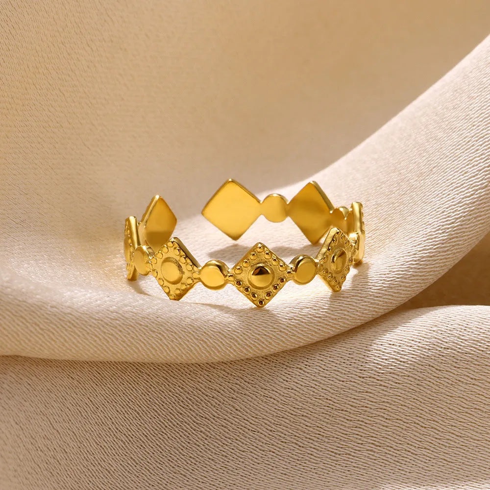 Gold diamond coloured titanium steel geometric women's ring on a free size band.