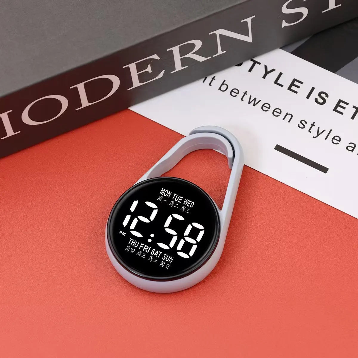 LED luminous electronic digital watch with plastic strap, shown in one of ten available colours on a wrist.