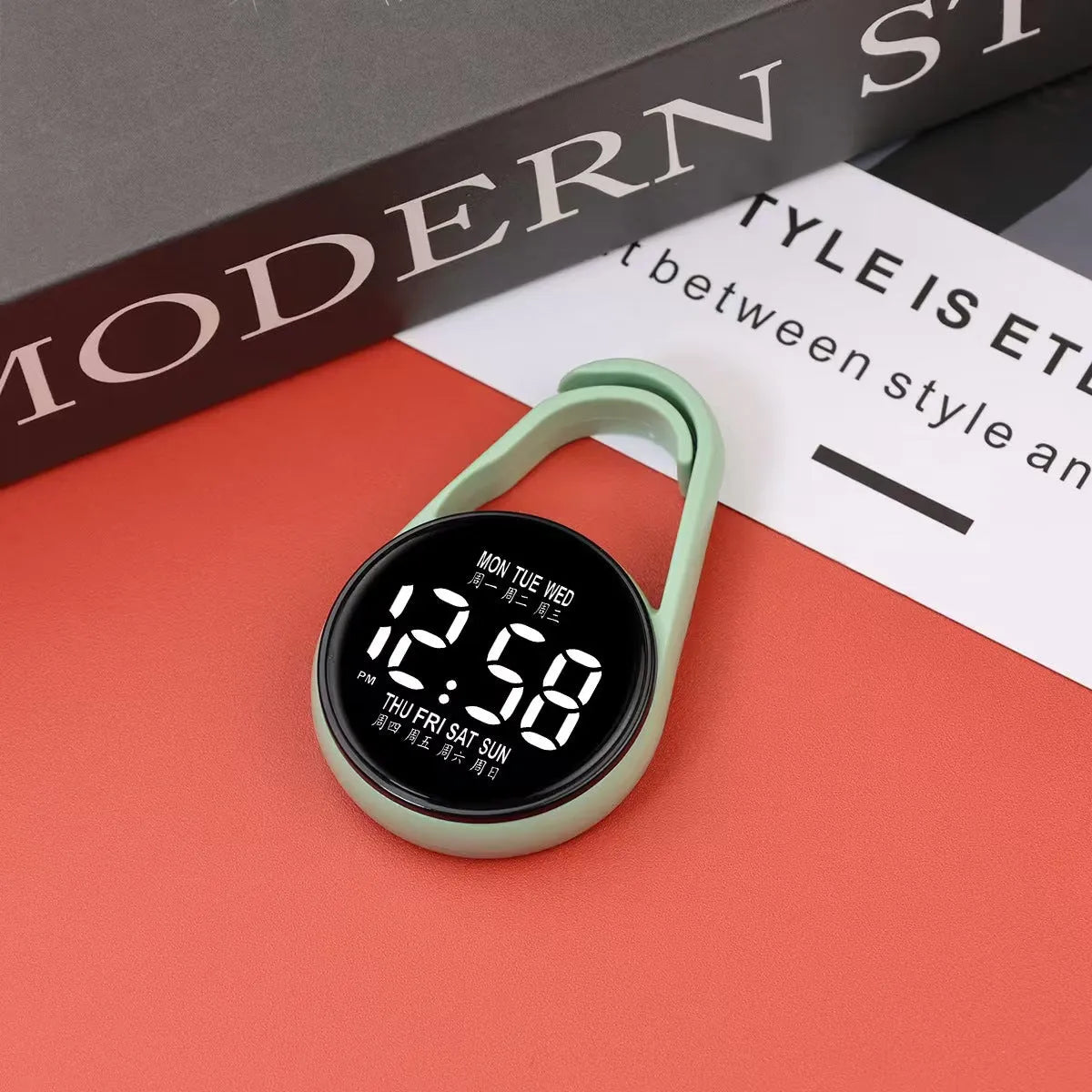 LED luminous electronic digital watch with plastic strap, shown in one of ten available colours on a wrist.