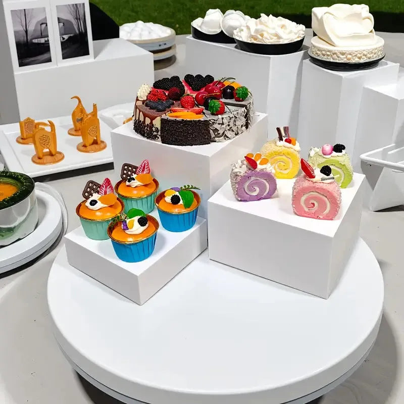 White plastic 6-piece interlocking cube dessert display stand showing tiered arrangement.