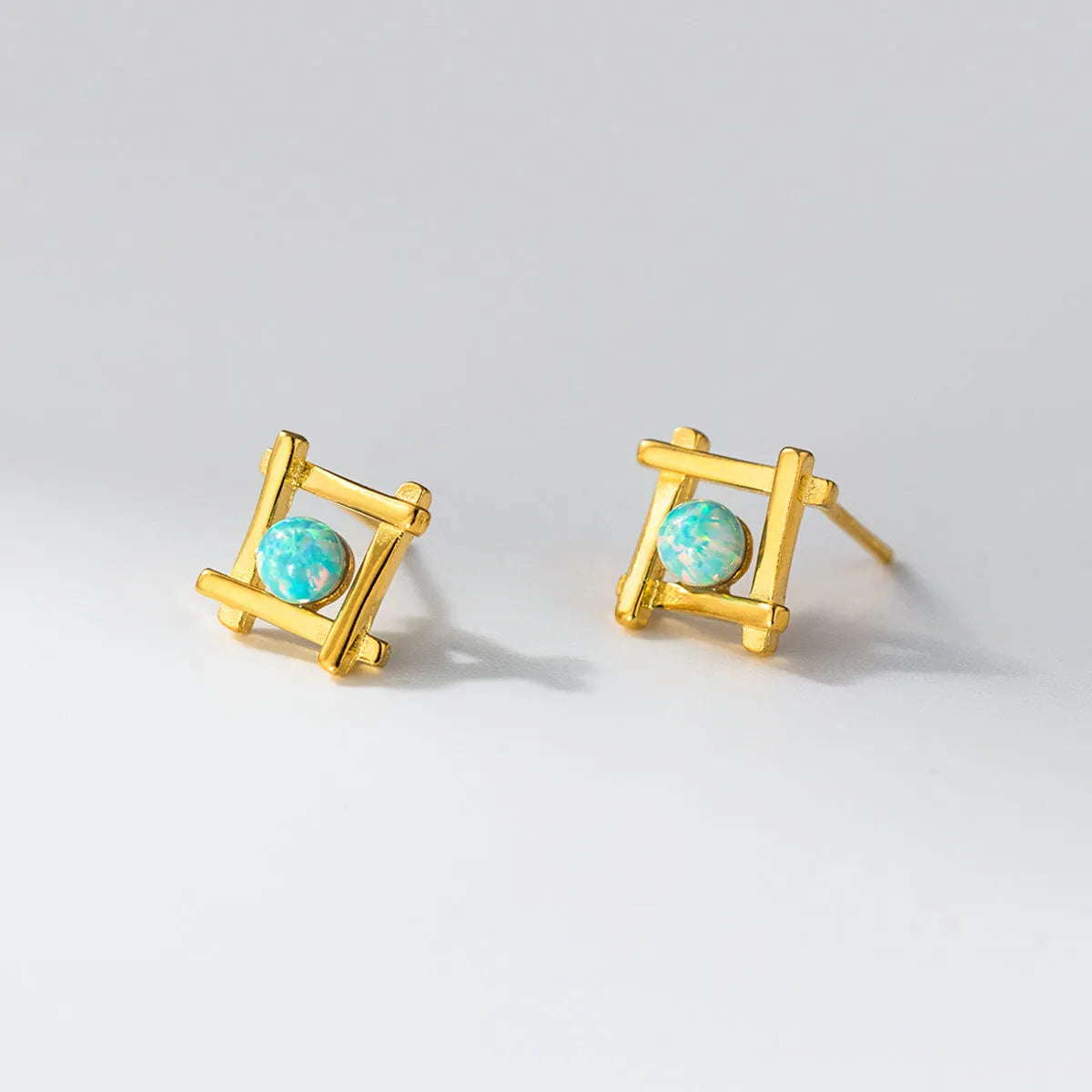 Geometric cross and quadrangle shape stud earrings for women in sterling silver.