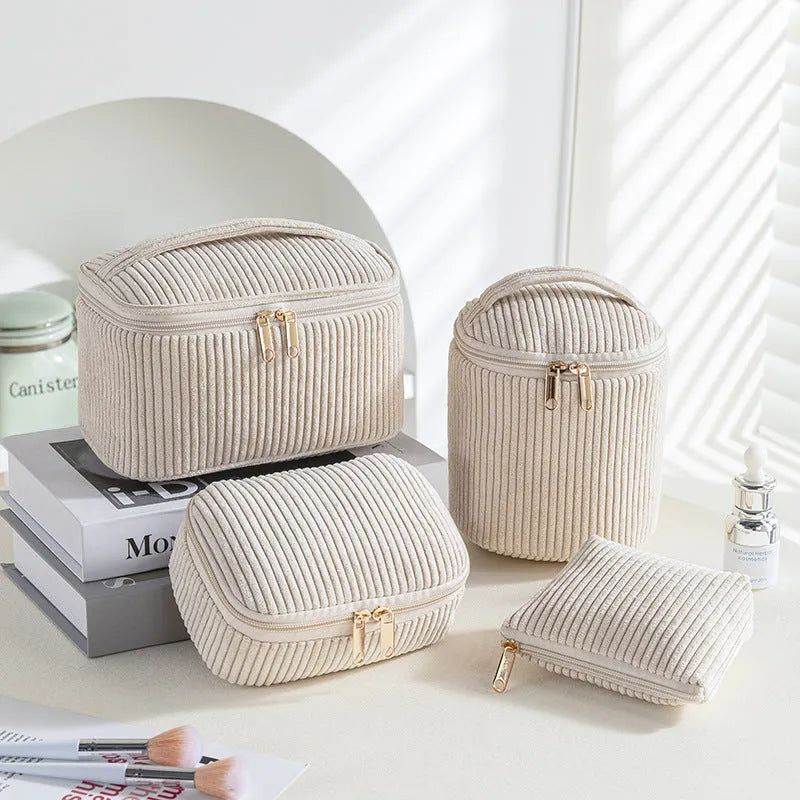 Four cube-shaped flannelette make-up bags in different colours: pink, khaki, pink dots, blue dots