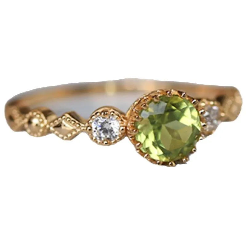 Close-up of a copper ring with a geometric quadrilateral shape and imitation peridot detail.