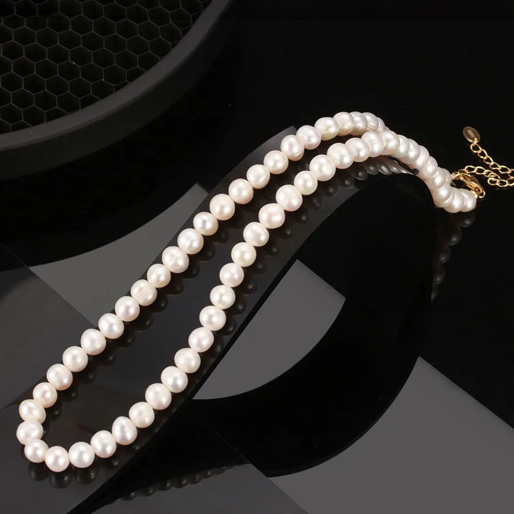 Close-up of a women's adjustable silver necklace with a single 6-7mm natural freshwater pearl pendant.