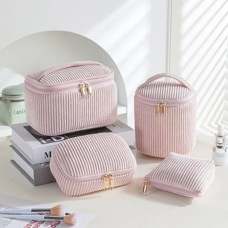 Four cube-shaped flannelette make-up bags in different colours: pink, khaki, pink dots, blue dots