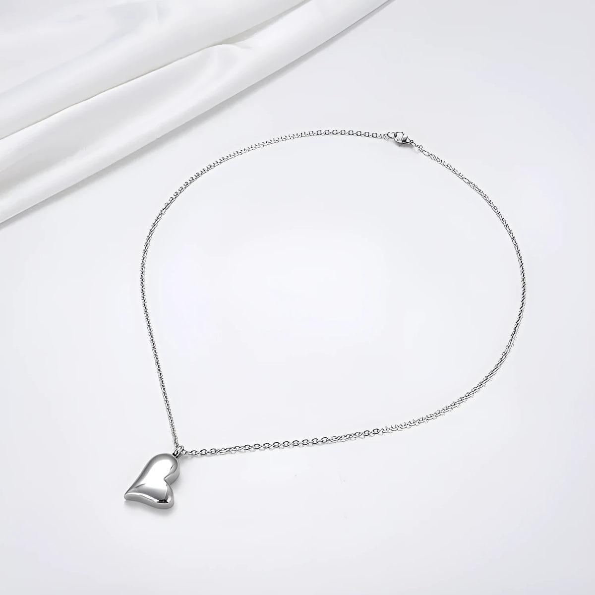 Silver curved peach heart pendant necklace on adjustable stainless steel chain