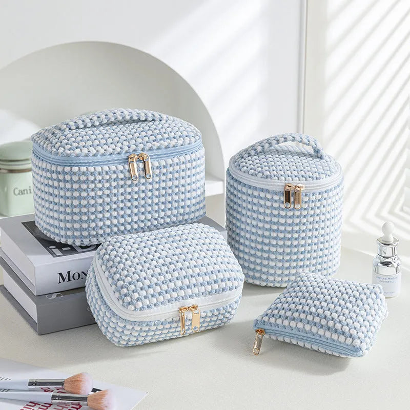 Four cube-shaped flannelette make-up bags in different colours: pink, khaki, pink dots, blue dots