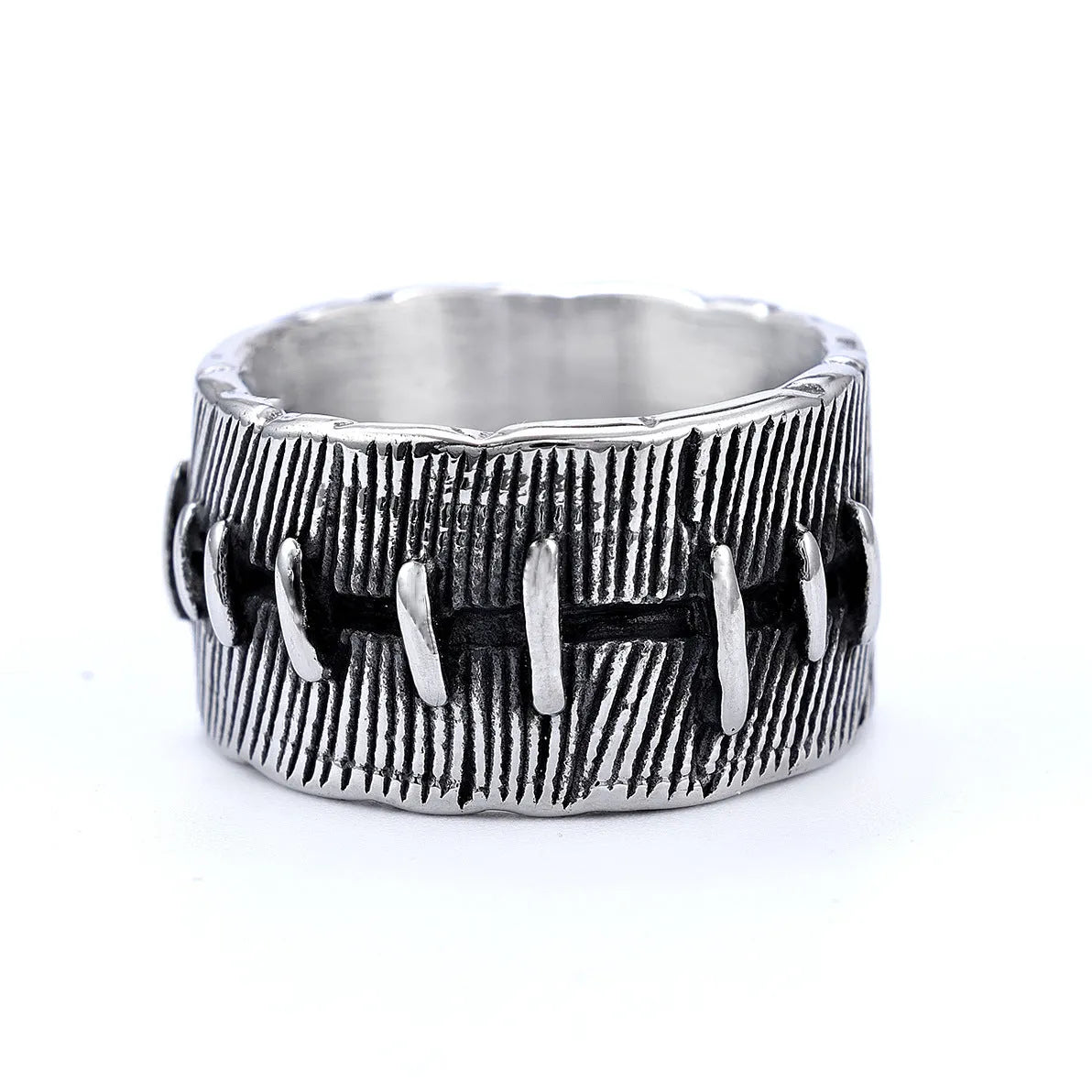 A geometric U-shaped dark punk double ring made from titanium steel in a retro colour, shown on a finger.