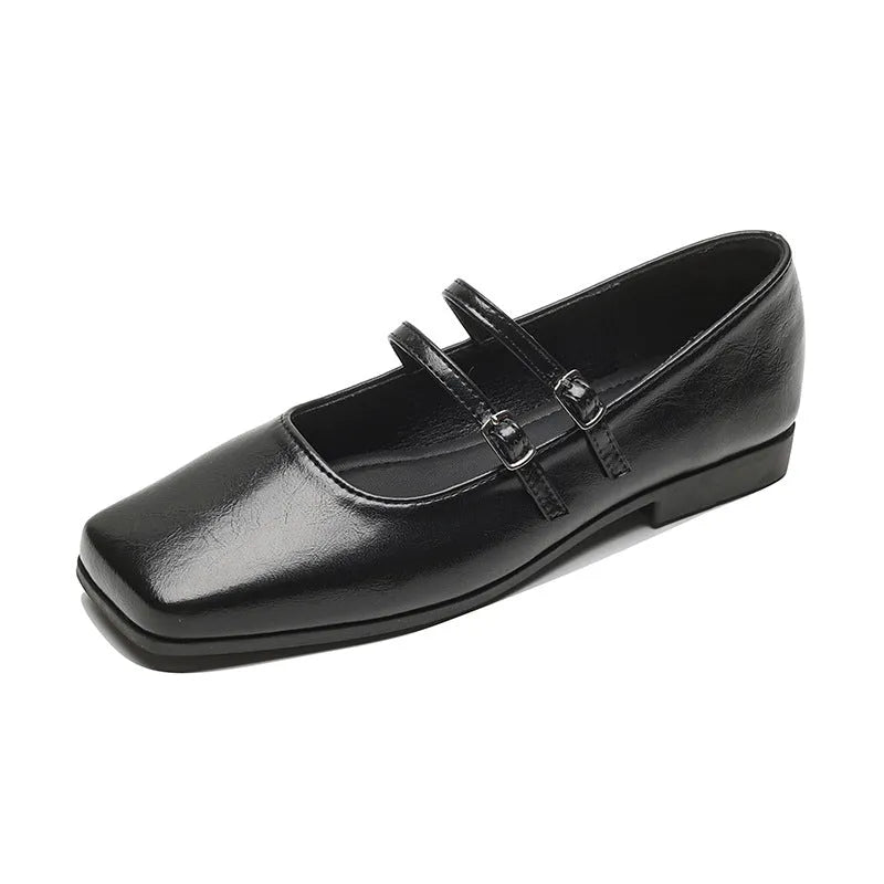 Silver women's leather ballet flats with a cross buckle strap and round toe.