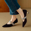 Women's black pointed stiletto heels with buckle closure and 3-5cm heel