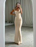 Backless milk silk sling dress in champagne colour with spaghetti straps and high waist