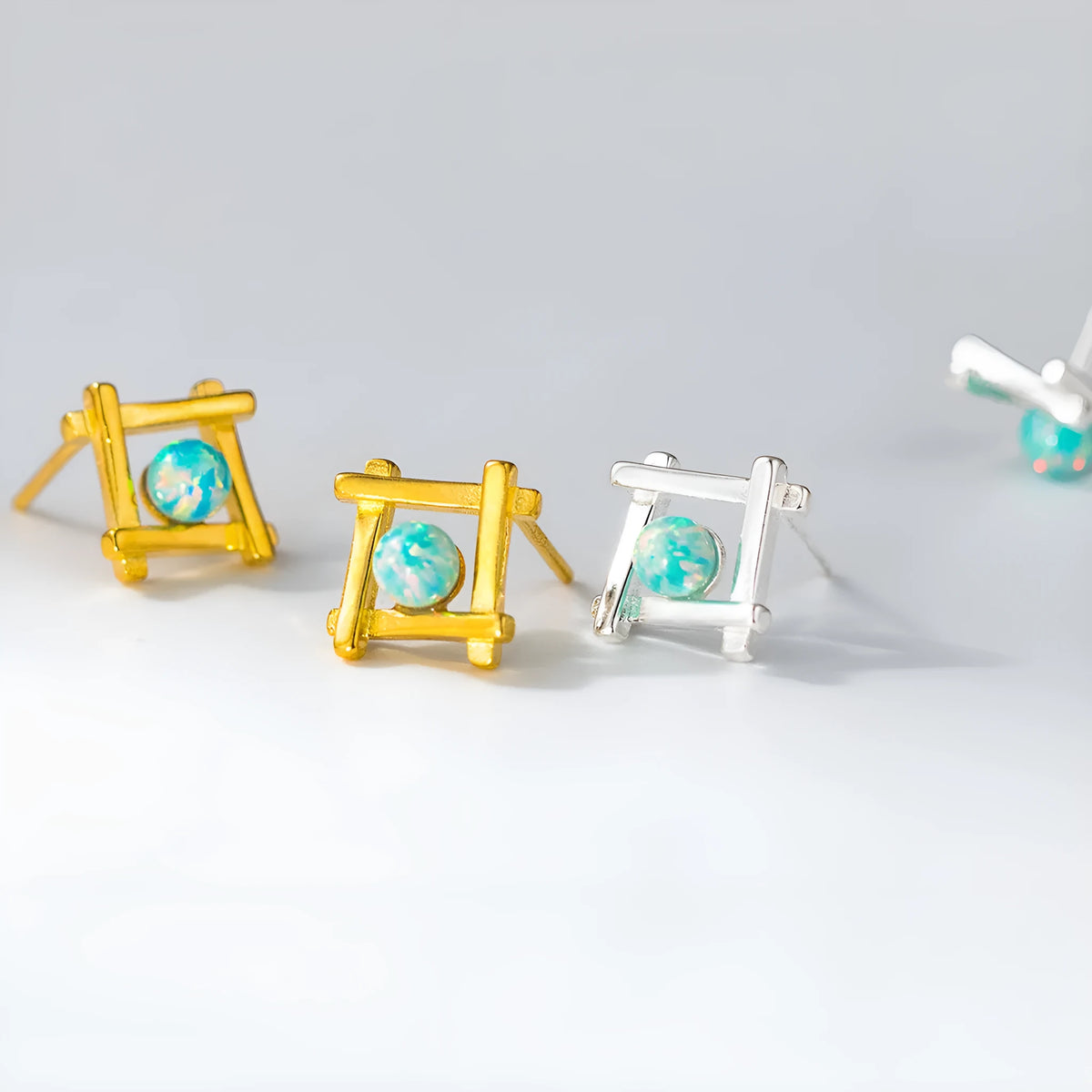 Geometric cross and quadrangle shape stud earrings for women in sterling silver.
