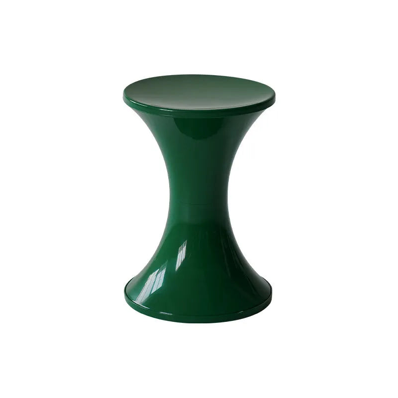 A plastic hourglass-shaped stool for changing shoes, shown in a green colour variant.