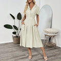 Light green lapel shirt dress with a waist tie and skirt pockets on a model.
