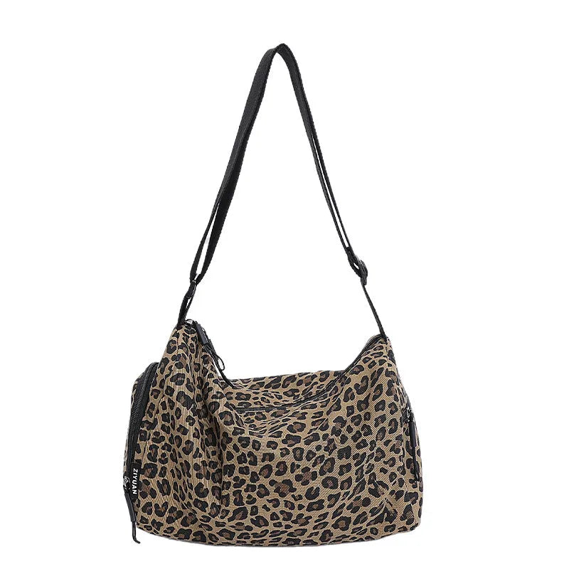 Sports-style cross-body messenger bag in leopard print pattern with decorative stitching details