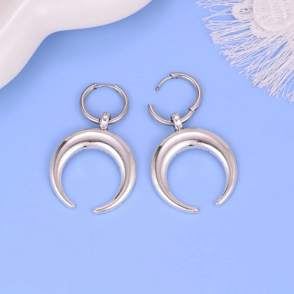 Silver alloy hoop earrings with moon detail and geometric shaping