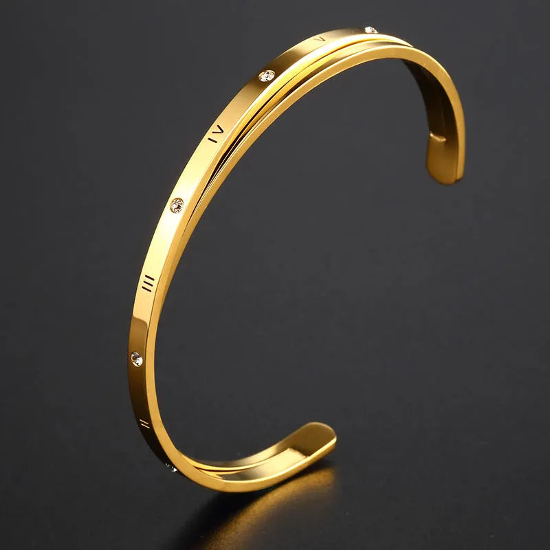 Open-ended stainless steel bracelet with inlaid zircon stones available in gold, rose, and steel colours
