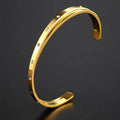 Open-ended stainless steel bracelet with inlaid zircon stones available in gold, rose, and steel colours