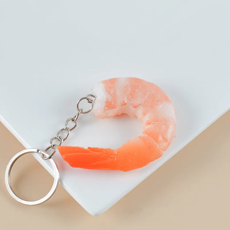 PVC injection moulded shrimp keychain with door buckle fastener on white background