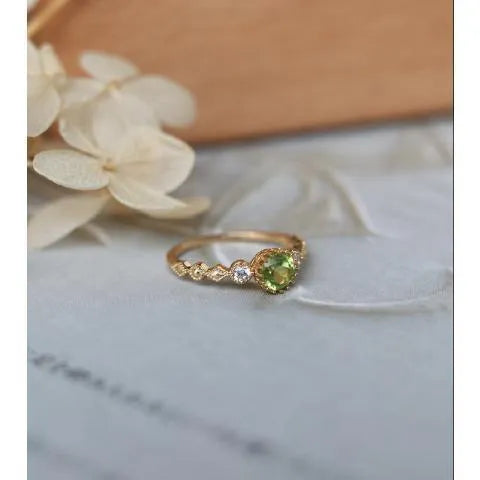 Close-up of a copper ring with a geometric quadrilateral shape and imitation peridot detail.