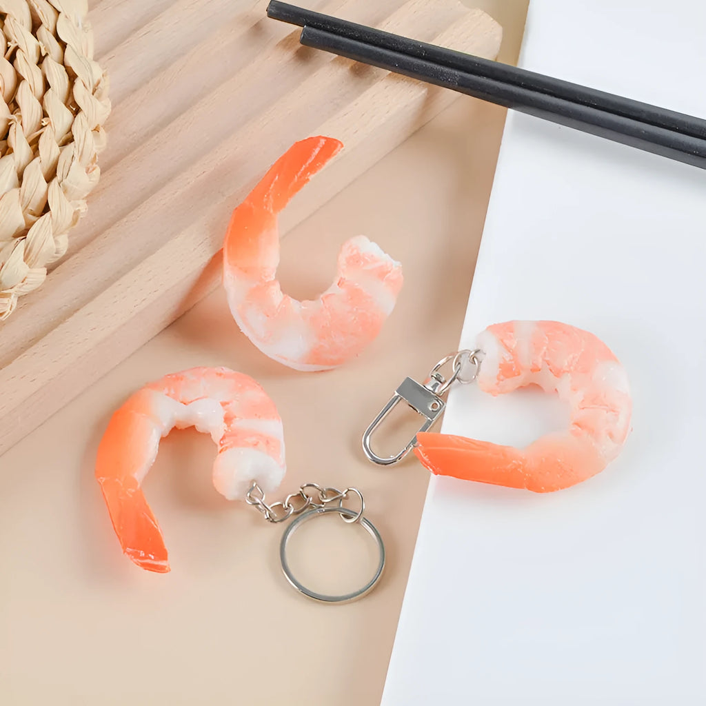 PVC injection moulded shrimp keychain with door buckle fastener on white background