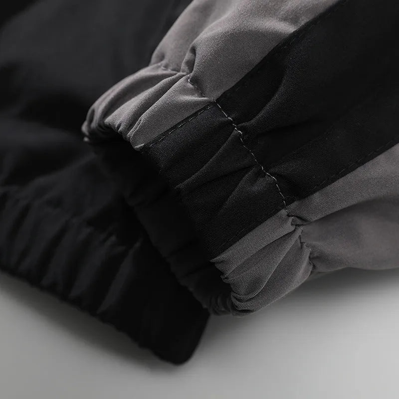 Men's black and dark blue colour block casual jacket with contrast stitching and side pockets.