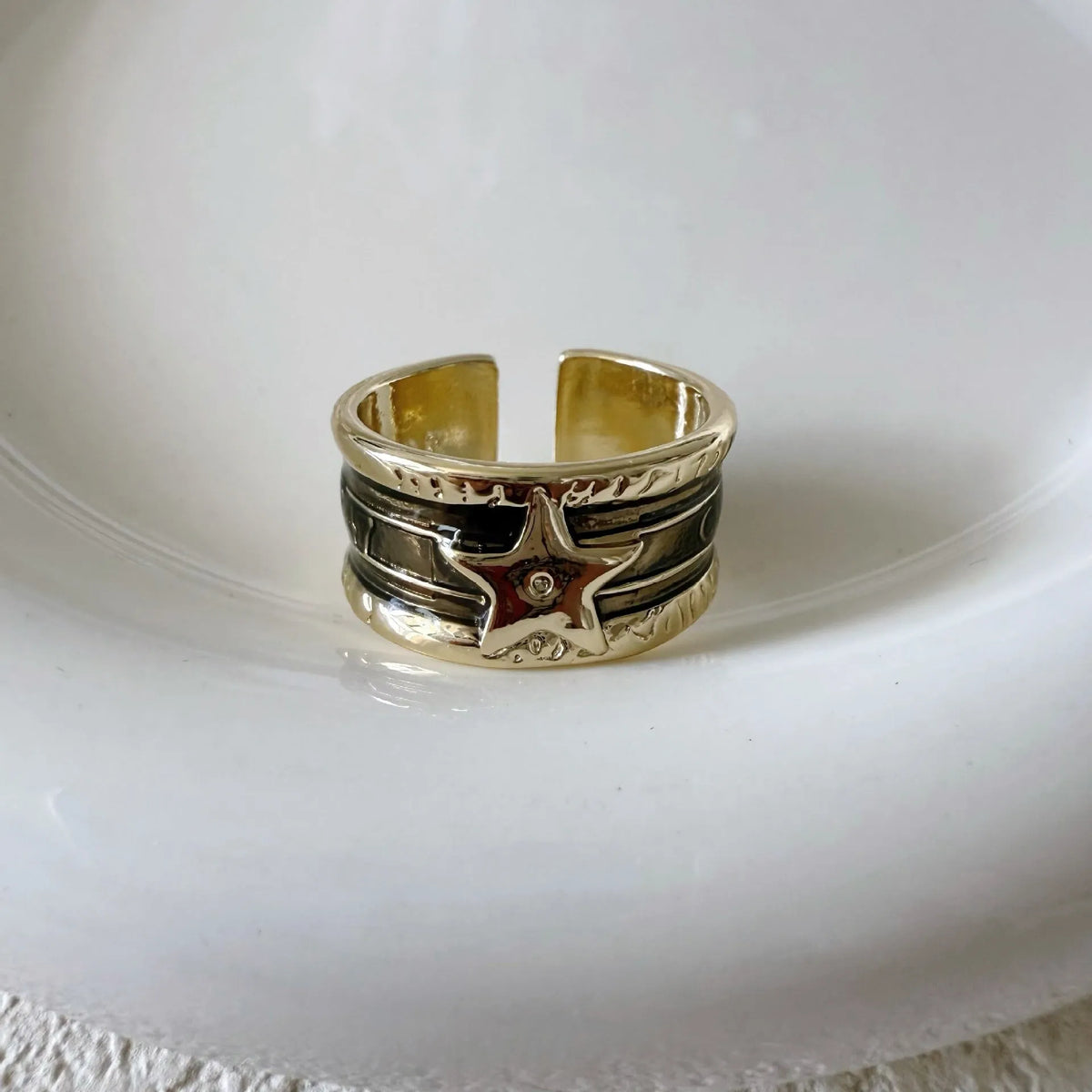Adjustable geometric drop oil ring for women in distressed copper, shown in multiple colour options.