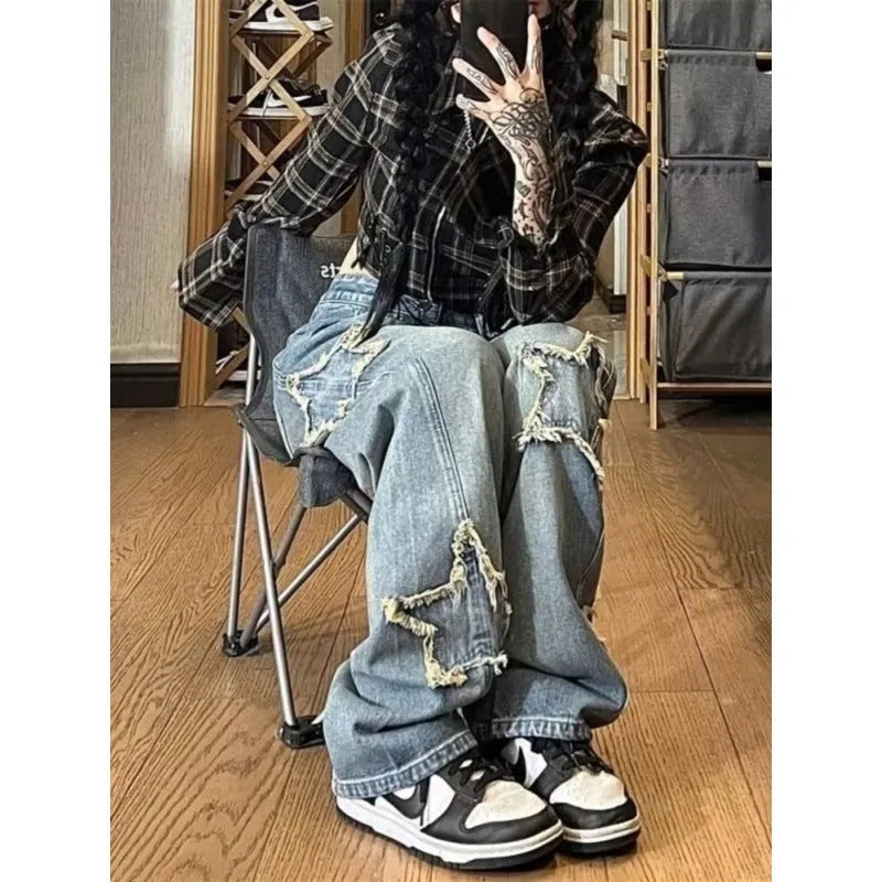 Blue women's high-waist straight-leg jeans laid flat, showing denim texture and button fly.
