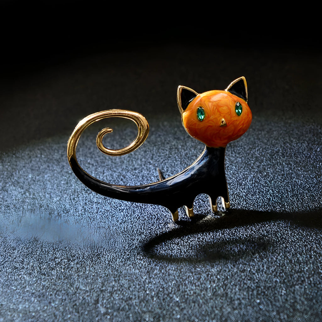 White and orange painted trailing up kitty brooch made from alloy metal