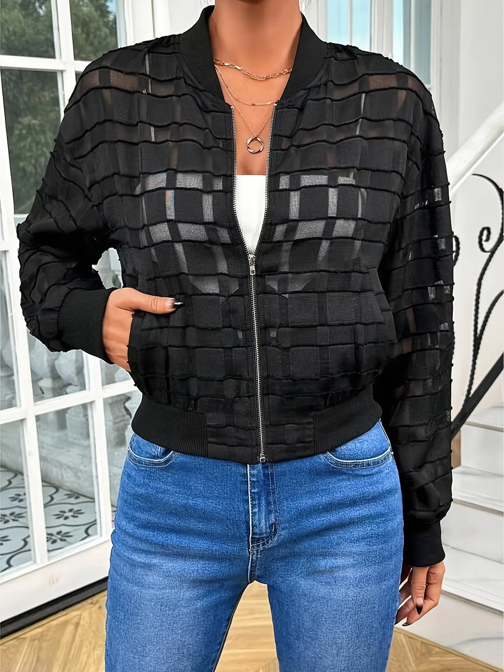 Black women's casual jacket with geometric pattern, semi-transparent fabric, long sleeves, and a front zipper.