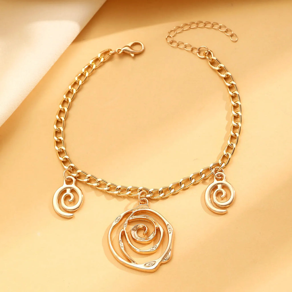 Gold or silver electroplated alloy jewellery set with spiral donut geometric shapes including necklace bracelet and ear hooks