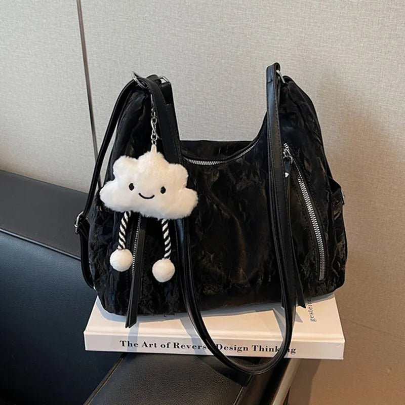 Women's soft PU leather fashion backpack in black, shown with detachable pendant.