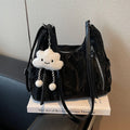 Women's soft PU leather fashion backpack in black, shown with detachable pendant.
