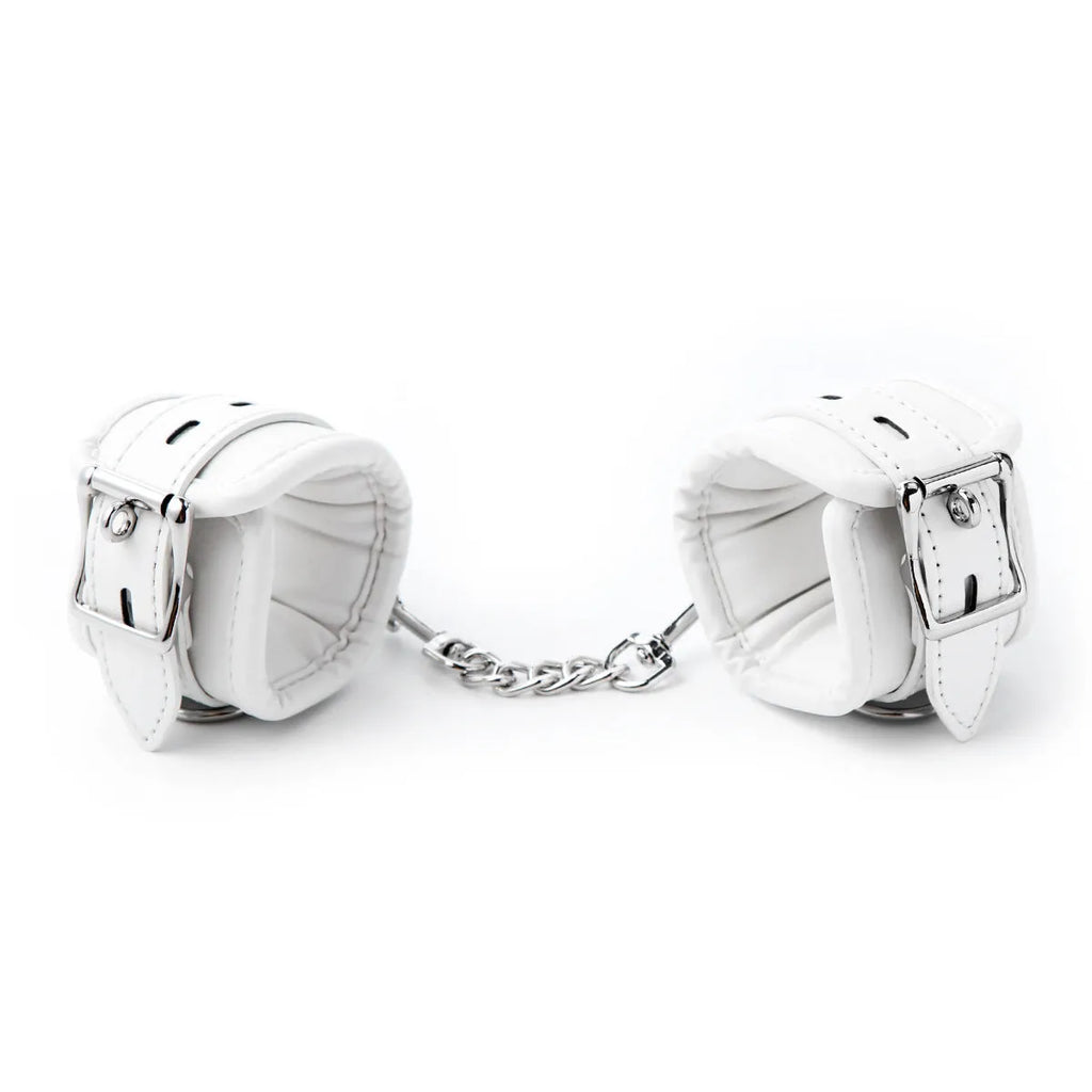 White PU sponge bondage set showing handcuffs, ankle cuffs, and a neck restraint collar.